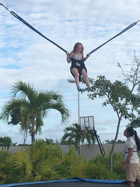 Bungee jumping on the trampoline with the Dreams Playa Mujeres kids club.