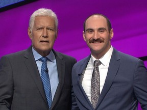 Alex Trebek hosts Season 36 of JEOPARDY!, with Vancouver contestant Evan Singer, right.