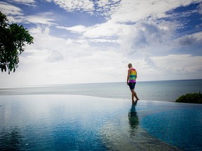 Jeff Perham walks on the edge of the infinity pool at the Bali resort Padma Resort Legian. As of April 5, he was the only guest left.