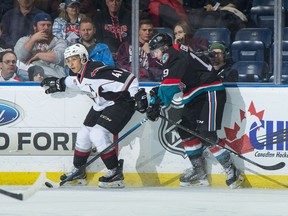 Giants defenceman Alex Kannok Leipert (left) battles along the boards with centre Ethan Ernst of the Kelowna Rockets during a WHL game last season in Kelowna.