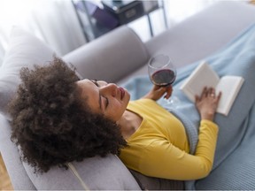 Woman drinking wine at home on sofa. Getty Images stock pic. For 0321 col gismondi [PNG Merlin Archive]