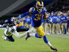 L.A. Rams running back Todd Gurley stiff arms cornerback Tre Flowers of the Seattle Seahawks on his way to a touchdown during their Dec. 8, 2019 NFL game at Los Angeles Memorial Coliseum.