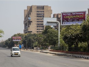 A car traverses a deserted road during a one-day nationwide curfew imposed as a preventive measure against COVID-19 on March 22, 2020 in New Delhi, India. The death toll due to coronavirus in India reached seven on Sunday with three more fatalities reported. Besides placing 75 districts with confirmed cases under lockdown until March 31, the government of Prime Minister Narendara Modi has shut down trains, both metro and inter-state services, in an effort to curb the spread of the global pandemic in India.