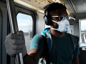 A man wears a medical mask on the AirTrain as concern over the coronavirus grows enroute to John F. Kennedy Airport (JFK) on March 7, 2020 in New York City. The number of global coronavirus infections has now surpassed 100,000, causing disruptions throughout the globe. The airline and travel industries has been especially hard hit by the outbreak, with both business and leisure travellers cancelling plans.