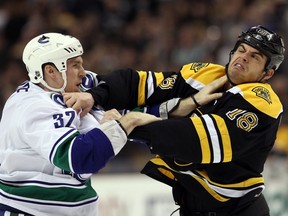 Dale Weise of the Vancouver Canucks and Nathan Horton paw at each other during a first-period fight on Jan. 7, 2012 in Boston. The Canucks won the game 4-3, and the fights were just as close — and contested.