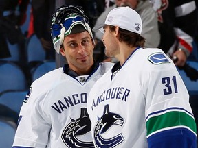 Roberto Luongo (left) is congratulated by his backup Eddie Lack after posting a shutout in Buffalo over the Sabres earlier in the 2013-14 NHL season. ‘He was such a good goalie, just to like be around him day to day, see how he prepared himself, how he practised, how much he cared,’ Lack says today of having Luongo as a teammate.’