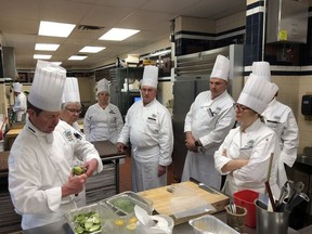 Students at the Culinary Institute of America look on as Chef David Bruno demonstrates a technique.