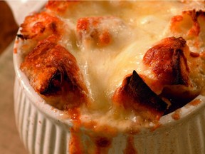 A golden topping of toasty croutons and gooey cheese crowns a bowl of Decadent French Onion Soup. Photo: Robert Shaer.