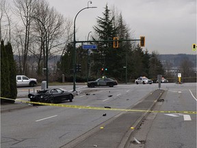 COQUITLAM, B.C.: MARCH 25, 2019 – The aftermath of the March 9, 2019, collision is pictured in Coquitlam, B.C. The wreckage of a black BMW and a black Dodge Charger sit at the intersection of Riverview Crescent and Mariner Way while police vehicles block the road. [PNG Merlin Archive]