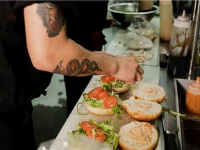 A cook prepares food at a BierCraft restaurant.