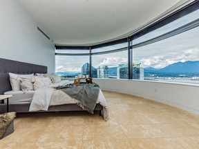 The two-level home at 838 West Hastings Street, Vancouver, features a gourmet Dada kitchen with Gaggenau appliances and a cantilevered electronic countertop, pre-wiring for touch pads, and a reconfigured master bedroom with a panoramic window wall.