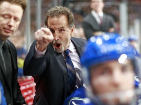 John Tortorella points an accusing finger at Flames coach Bob Hartley.