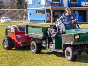 Juan de Fuca electoral area director Mike Hicks, accompanied by his dog, six-year-old Patches, deploys a new machine behind a little truck to sweep up goose droppings from playing fields at the Sooke Soccer Club.