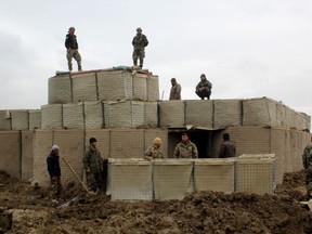 Afghan security forces stand guard at an Afghan National Army (ANA) outposts after an attack by Taliban militants, in Kunduz Province on March 4, 2020.