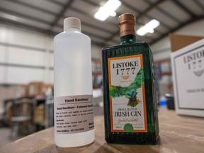 A bottle of newly produced and bottled hand sanitizer (left) and a bottle of Irish Gin are pictured at Listoke Distillery and Gin School in Tenure, north of Dublin in Ireland, on March 18, 2020.