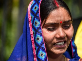 Punita Devi, wife of Akshay Thakur, one of the four men convicted for the gang-rape and murder case of a student, reacts as she speaks to media representatives, outside the Patiala House Court in New Delhi on March 19, 2020. (PRAKASH SINGH/AFP via Getty Images)