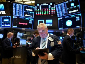 Traders work during the opening bell at the New York Stock Exchange (NYSE) on March 19 at Wall Street in New York City.