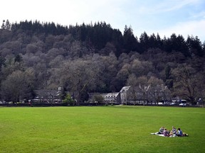 A family eat a picnic on a playing field at Betws-y-Coed in north Wales on March 23, 2020.