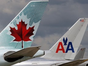 Air Canada and American Airlines aircraft stand at Heathrow airport in London, U.K., in 2010.