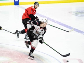 Bowen Byram of the Vancouver Giants tries to skate away from Tyson Upper of the Prince George Cougars on Friday.