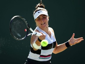 Bianca Andreescu, seen here in final round action at the 2019 Indian Wells tournament, will not defend her title later this month due to a knee injury.