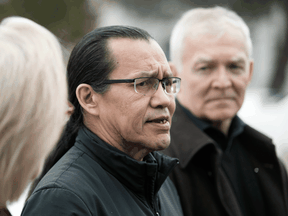 Wet'suwet'en hereditary leader Chief Woos, centre, Crown-Indigenous Relations Minister Carolyn Bennett, and B.C. Indigenous Relations Minister Scott Fraser arrive to speak to reporters in Smithers on March 1.