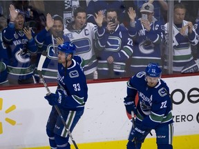 Fans take pictures of Henrik Sedin, left, and Daniel Sedin as the Vancouver Canucks prepare for the twins final NHL game at Rogers Arena on April 5, 2018. The Canucks beat the Arizona Coyotes 4-3 in overtime.