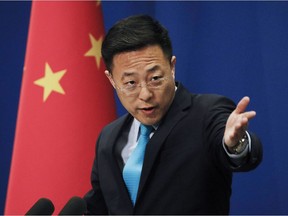 Chinese Foreign Ministry new spokesman Zhao Lijian gestures as he speaks during a daily briefing at the Ministry of Foreign Affairs office in Beijing, Monday, Feb. 24, 2020. China's foreign ministry on Monday said it didn't matter that three expelled journalists had nothing to do with a Wall Street Journal editorial that Beijing deemed racist, and called on the paper to apologize.