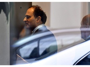 David Sidoo, of Vancouver, enters an adjacent building with his lawyer following a federal court hearing Friday, March 15, 2019, in Boston. Sidoo faced charges of conspiracy to commit mail and wire fraud as part of a wide-ranging college admissions bribery scandal.