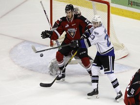 Vancouver Giants defenceman Seth Bafaro and Victoria Royals forward Gary Haden make plays on the puck in front of the Vancouver net on Sunday.