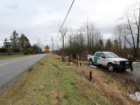 A U.S. Border Patrol officer enters his vehicle on the United States side of the Canada-U.S. border, opposite a road on the Canadian side in Langley.