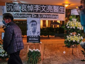 People wearing masks attend a vigil for the late Dr. Li Wenliang, an ophthalmologist who died of coronavirus at a hospital in Wuhan, in Hong Kong, China on Feb. 7, 2020.