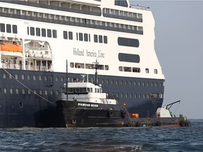 An offshore supply vessel is seen next to the cruise ship MS Rotherdam, which brought supplies and Covid-19 test kits to the MS Zaandam, where four passengers died, pictured off the coast of Panama City, Panama March 27, 2020.