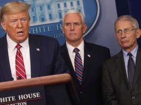 U.S. President Donald Trump addresses the daily coronavirus task force briefing as Vice President Mike Pence and National Institute of Allergy and Infectious Diseases Director Anthony Fauci look on at the White House in Washington, D.C., on March 20, 2020.
