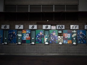 Photos of Vancouver Canucks players are posted next to closed ticket windows outside Rogers Arena in Vancouver. The NHL suspended its season because of concerns over the coronavirus pandemic.