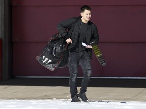 Calgary Hitmen defencemen Jett Woo leaves the Scotiabank Saddledome on Sunday.