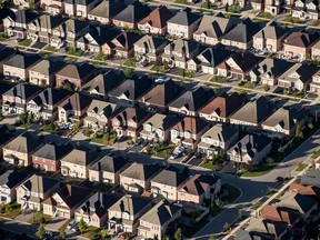 Homes stand in this aerial photograph taken above Toronto, Ontario. Some are concerned that lower interest rates will fuel froth in Canada’s housing market.