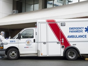 A B.C. ambulance paramedic is seen outside the Lions Gate Hospital in North Vancouver, B.C. Monday, March 23, 2020.