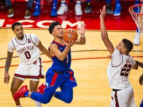 Guard Devon Dotson of the Kansas Jayhawks leaps to shoot the ball over forward TJ Holyfield of the Texas Tech Red Raiders on March 7, 2020 at United Supermarkets Arena in Lubbock, Texas. (John E. Moore III/Getty Images)