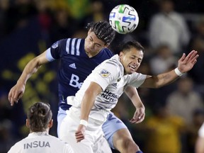 Vancouver Whitecaps defender Jasser Khmiri, left, battles LA Galaxy forward Javier Hernandez, right, for a header during the first half of an MLS soccer match in Carson, Calif., Saturday, March 7, 2020.