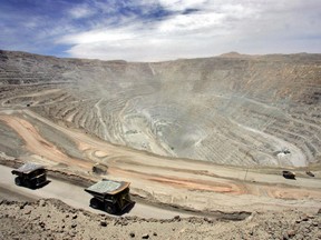 A couple of gigantic Komatsu 930, 330-metric-ton trucks arrive with their load at the Chuquicamata copper mine, 1,000 km north of Santiago, Chile, in 2005.