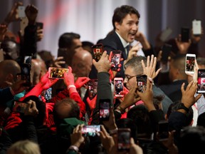 People takes pictures with their phones as Liberal Leader and Canadian Prime Minister Justin Trudeau appears to deliver his victory speech at his election night headquarters on October 21, 2019 in Montreal, Canada. Trudeau promised during the 2019 election campaign to lower cell phone costs for consumers by 25 per cent, saving the average family of four $1,000 per year, based on 2018 prices.