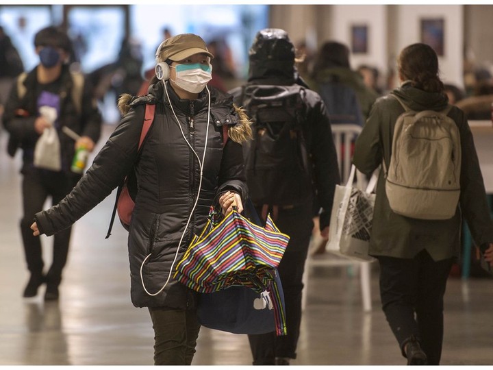  Students at UBC take precautions and wear surgical masks on Monday. Building operations staff are cleaning touch surfaces such as door knobs and faucets on a daily basis.
