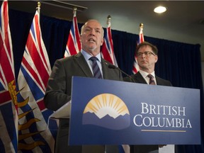 B.C. Premier John Horgan, with Health Minister Adrian Dix, right, didn't have a lot of positive news to share on Tuesday, but his government has plans to combat the ramifications of the novel coronavirus outbreak.