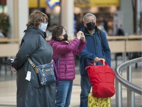 Nervous and masked travellers arrive at Vancouver International Airport on Friday. Due to the global threat of COVID-19, flying has been greatly curtailed.