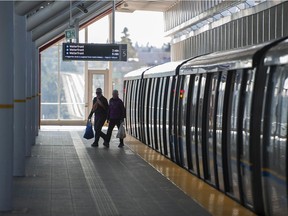 Transit users at the Commercial — Broadway SkyTrain station in Vancouver on Saturday, March 14, 2020. Some people are avoiding transit due to COVID-19.