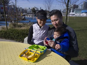 Nan Maung and Jimmy Yang with their 18-month-old son Emery Yang at the Science World playground on Thursday.