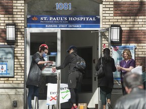 Visitors to St. Paul's Hospital in Vancouver, BC are screened before they enter the hospital Friday, March 20, 2020.