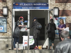 Visitors to St. Paul's Hospital in Vancouver, BC are screened before they enter the hospital Friday, March 20, 2020. Due to the Covid-19 virus outbreak, health officials are stressing that social spacing is important to stop the spread of the virus.