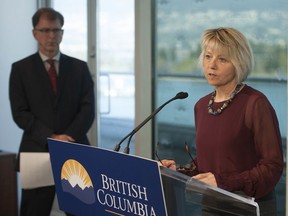 Adrian Dix, Minister of Health (at left) , and Dr. Bonnie Henry, provincial health officer (foreground-right) give an update on BC's Covid-19 pandemic.